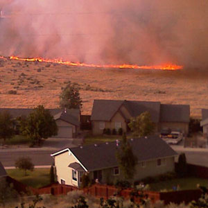 A fire burning towards a community.
