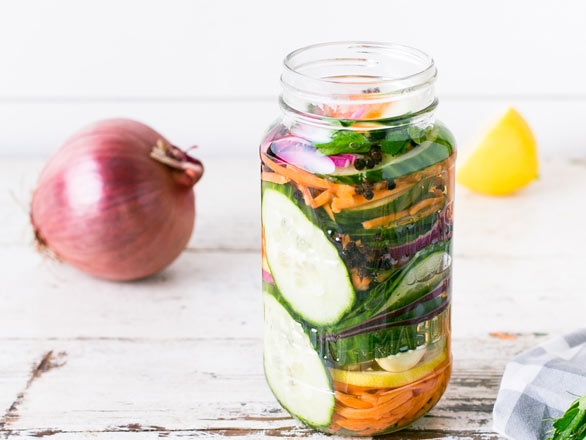 canning cucumber, carrots and onion in jar